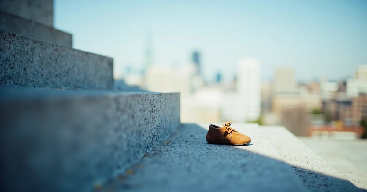 Low-angle view of Philadelphia Museum of Art steps with one small toddler shoe left on a tread.